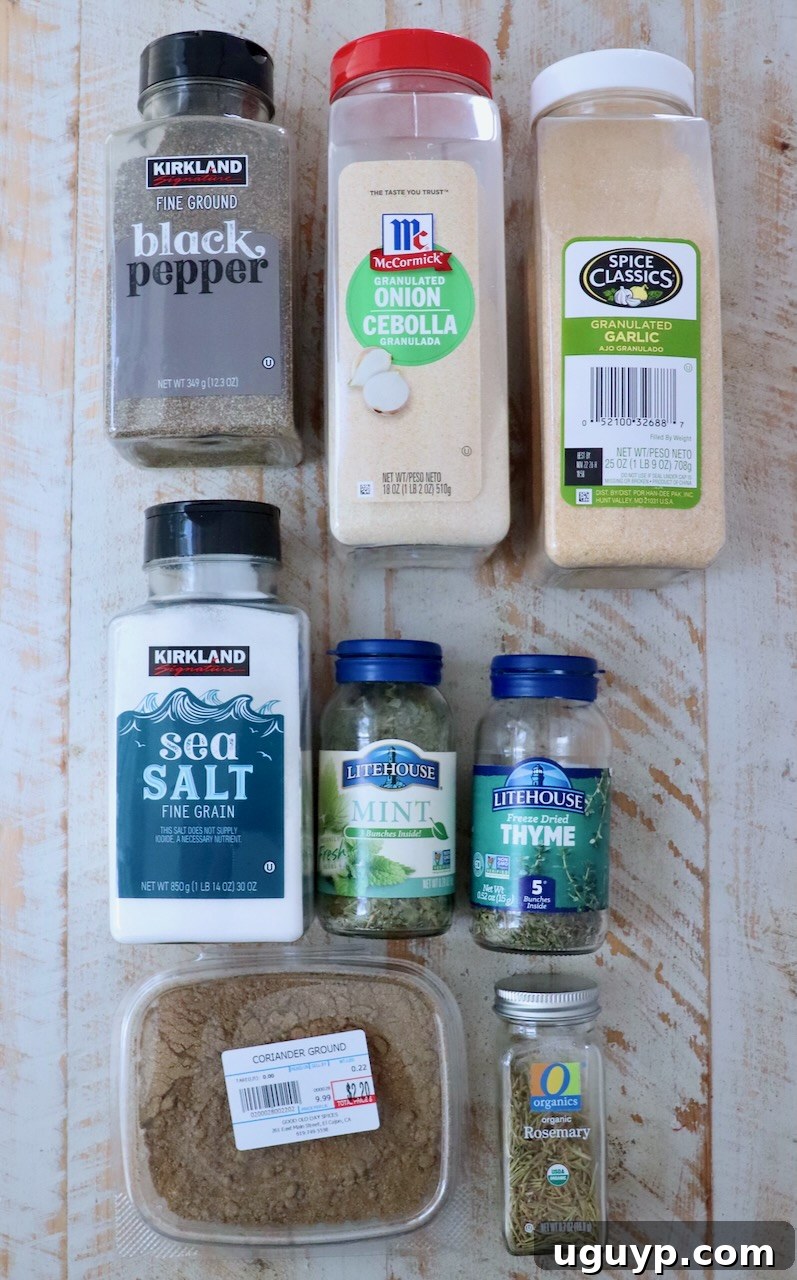dried herbs and spices in plastic containers on a white wood board, ready to be mixed into a flavorful lamb seasoning