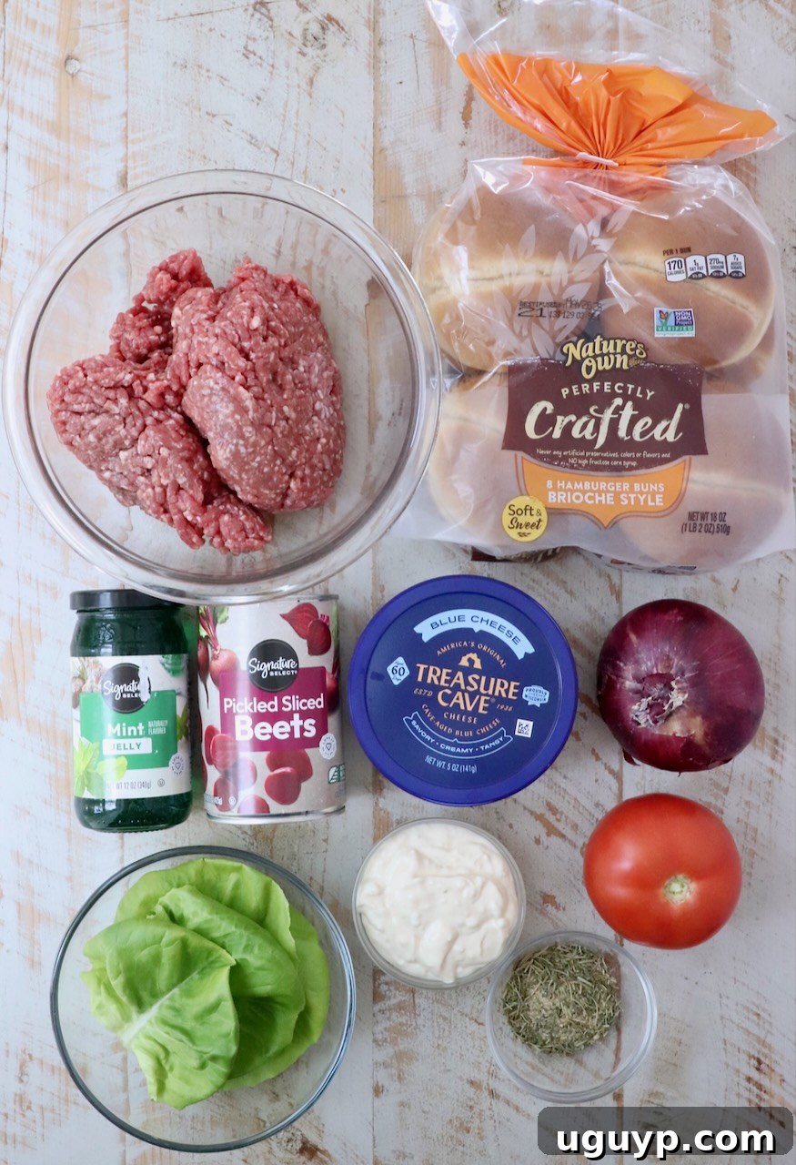 ingredients for lamb burger on a white wood board