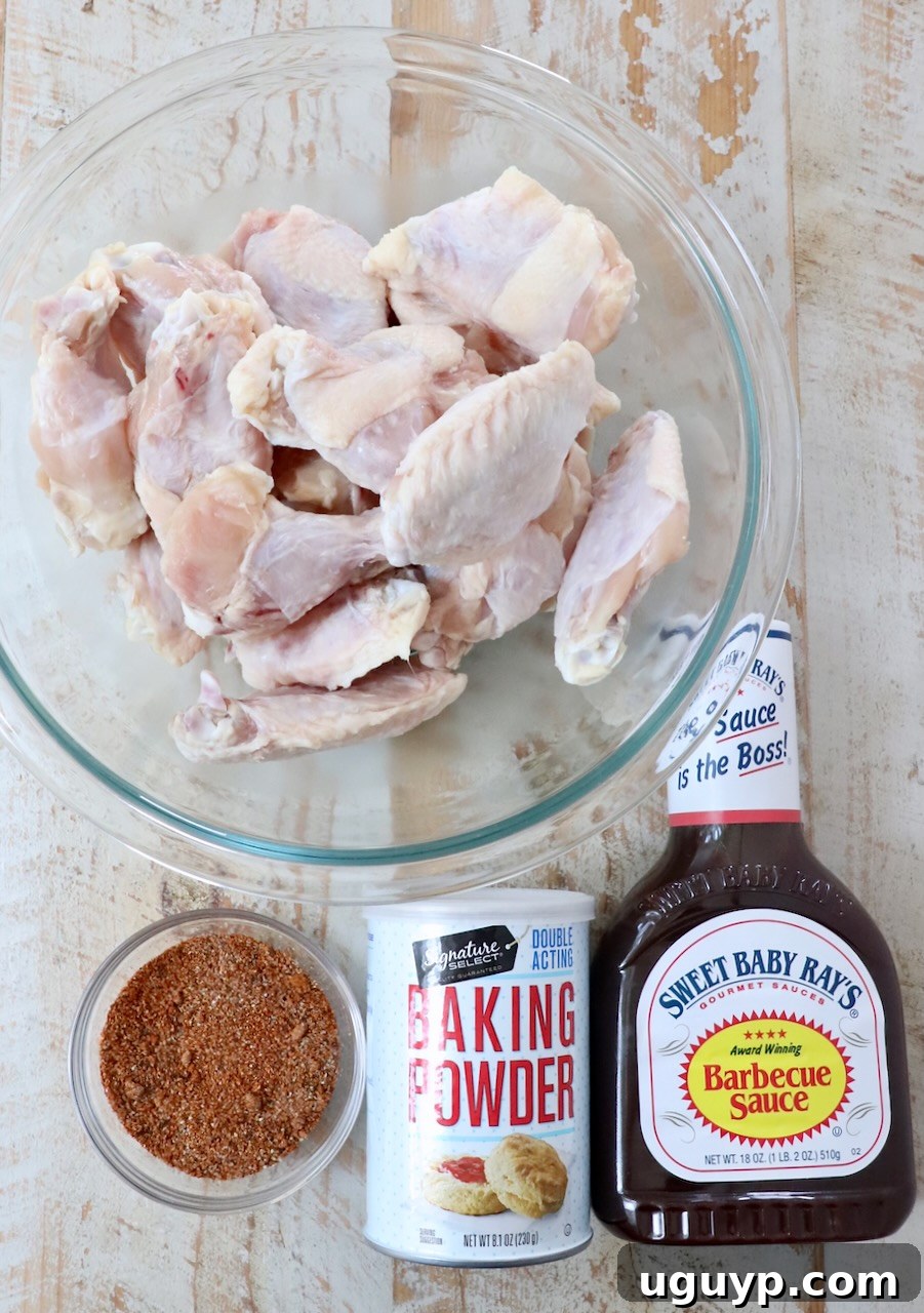 ingredients for bbq chicken wings on a white wood board