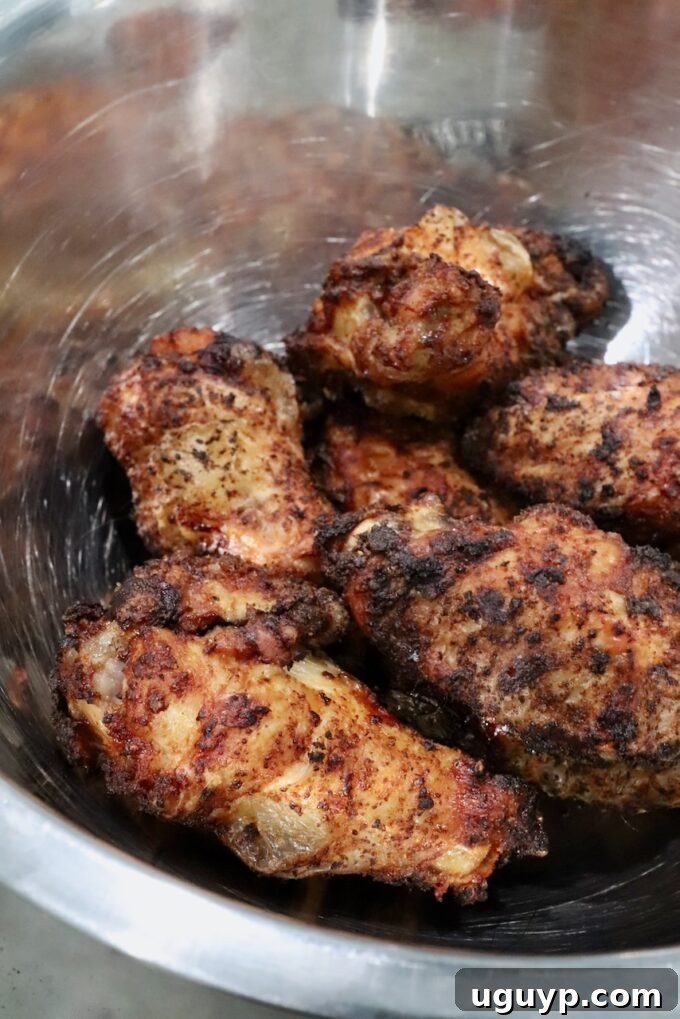 seasoned cooked chicken wings in a metal bowl