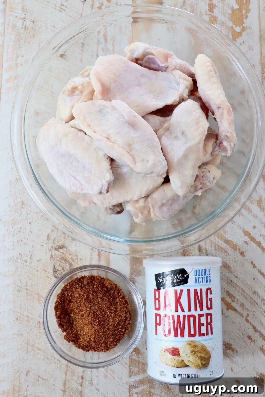 A selection of ingredients laid out on a white wooden board, ready for making cajun chicken wings.