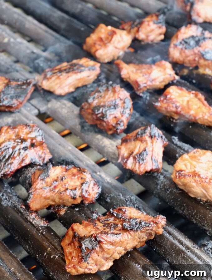 Perfectly grilled steak tips, exhibiting a desirable char and juicy appearance.