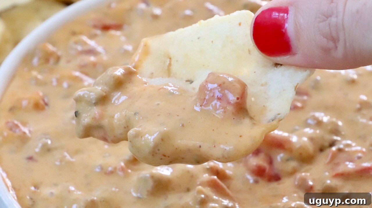 Classic Rotel Dip with Velveeta, ground beef, and taco seasoning, perfect for parties.