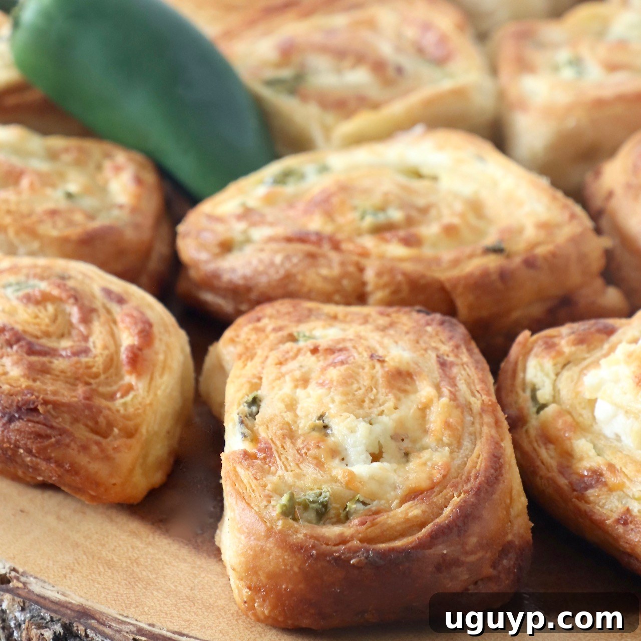 Jalapeno Popper Crescent Rolls arranged on a wooden serving tray.