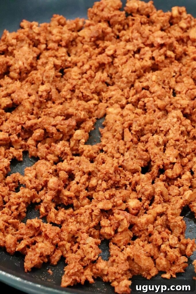 Crumbled soy chorizo sizzling in a hot skillet, cooking to perfection for crispy tacos.