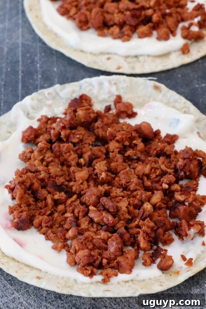 Perfectly cooked, crumbled soy chorizo generously placed on top of a tortilla already coated with a layer of creamy white queso.