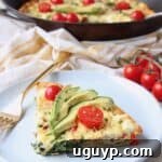 A delicious slice of spinach frittata with bacon and goat cheese on a plate.