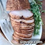 Expertly sliced smoked turkey breast, arranged on a pristine white platter, highlighting its flavorful spice crust. Fresh herbs complement the dish, with a carving fork suggesting readiness for serving.