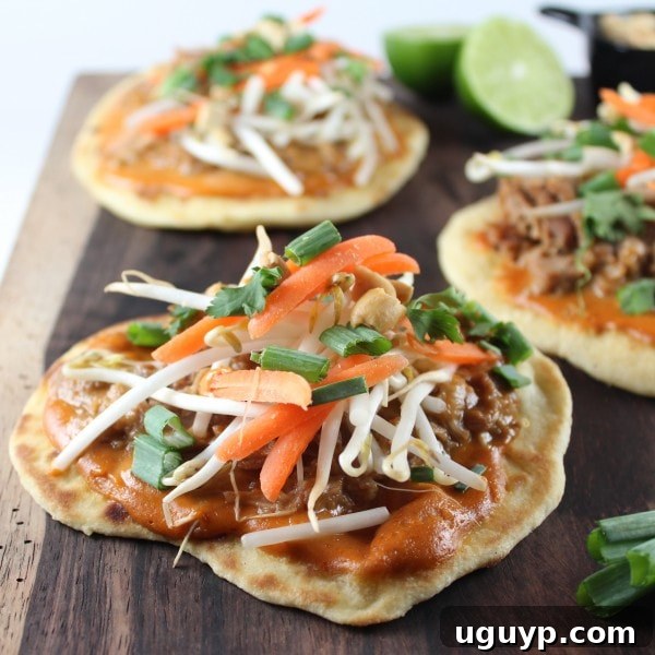 Two grilled Roti Bread Pulled Pork Pizzas fresh off the grill, ready for toppings.