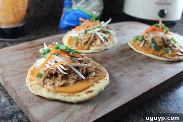 Grilled Thai Peanut Pulled Pork Pizzas topped with fresh bean sprouts, carrots, and cilantro.