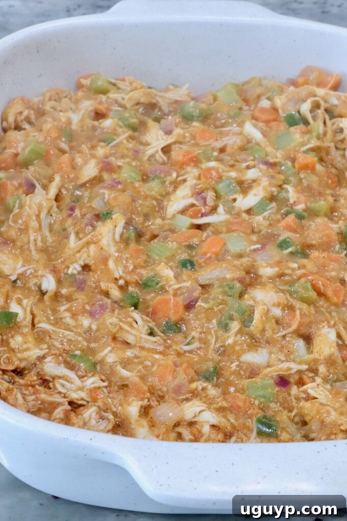 buffalo chicken pot pie filling in a baking dish
