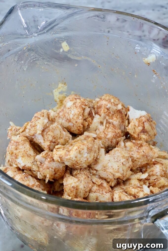 seasoned cubes of uncooked biscuit dough in a glass bowl