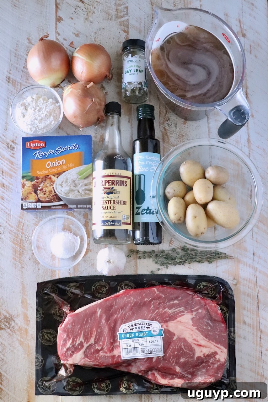 Overhead shot of all the key ingredients for French onion beef stew meticulously arranged on a rustic wooden board. Ingredients include cubed chuck roast, vibrant red potatoes, sliced yellow onions, whole garlic cloves, a bottle of rich beef stock, Worcestershire sauce, olive oil, fragrant bay leaves, and a selection of seasonings.