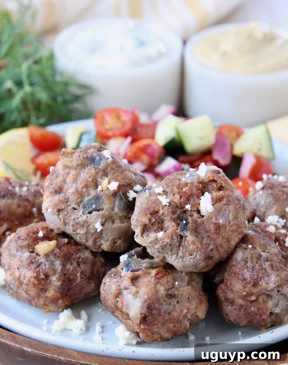 Greek meatballs on plate topped with crumbled feta cheese