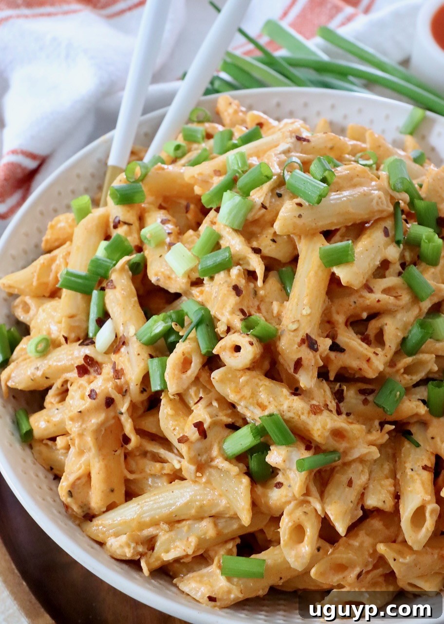 Delicious Buffalo Chicken Pasta in a bowl, garnished with fresh green onions.