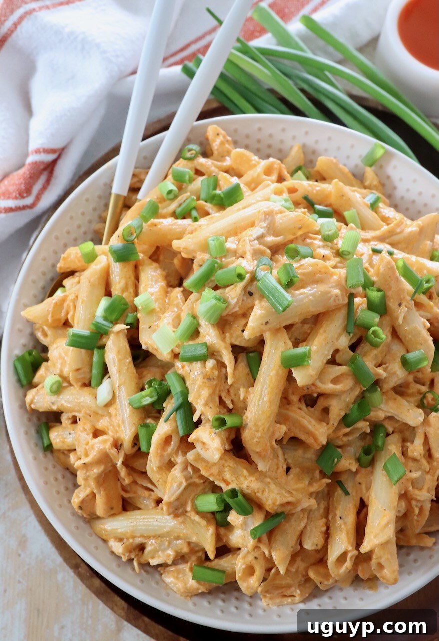 A bowl of creamy Buffalo Chicken Pasta, ready to be enjoyed, with forks inserted.