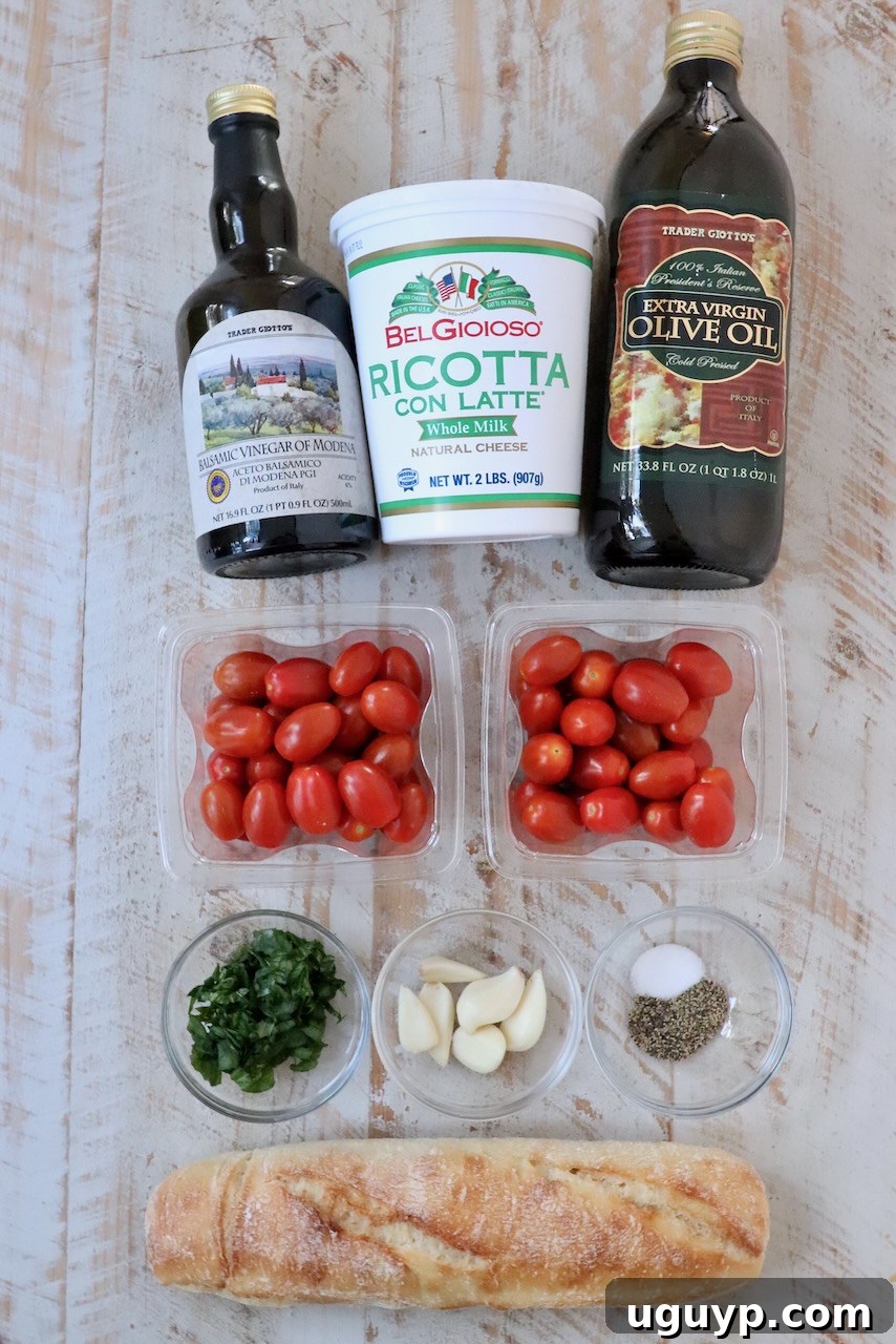 ingredients for tomato ricotta bruschetta on a white wood board