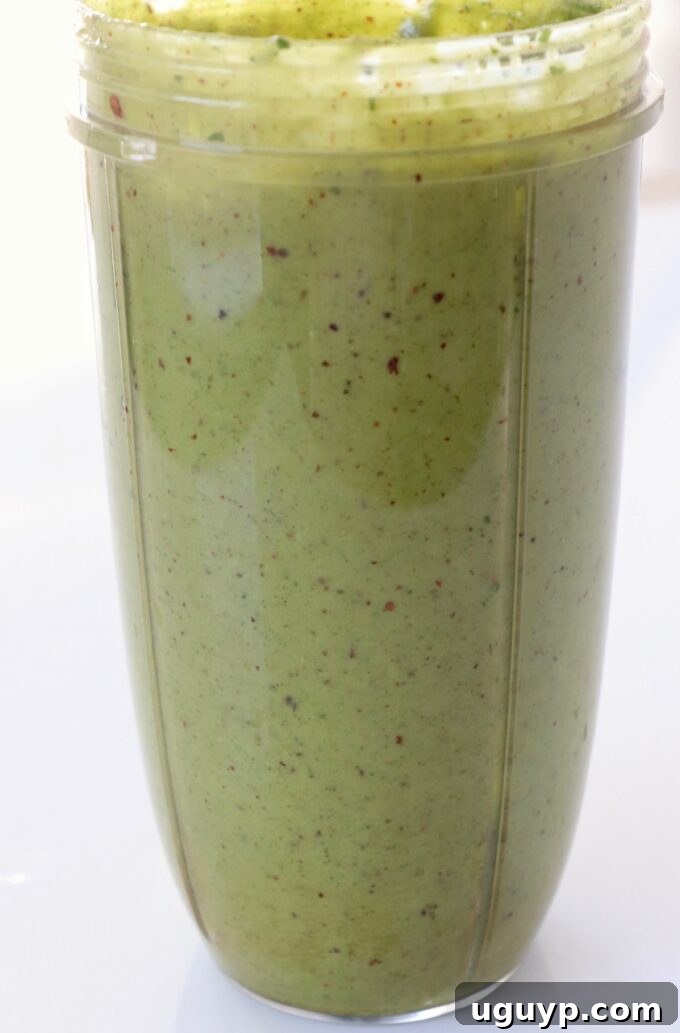 Spicy cashew dressing in a blender cup, showcasing its creamy texture.