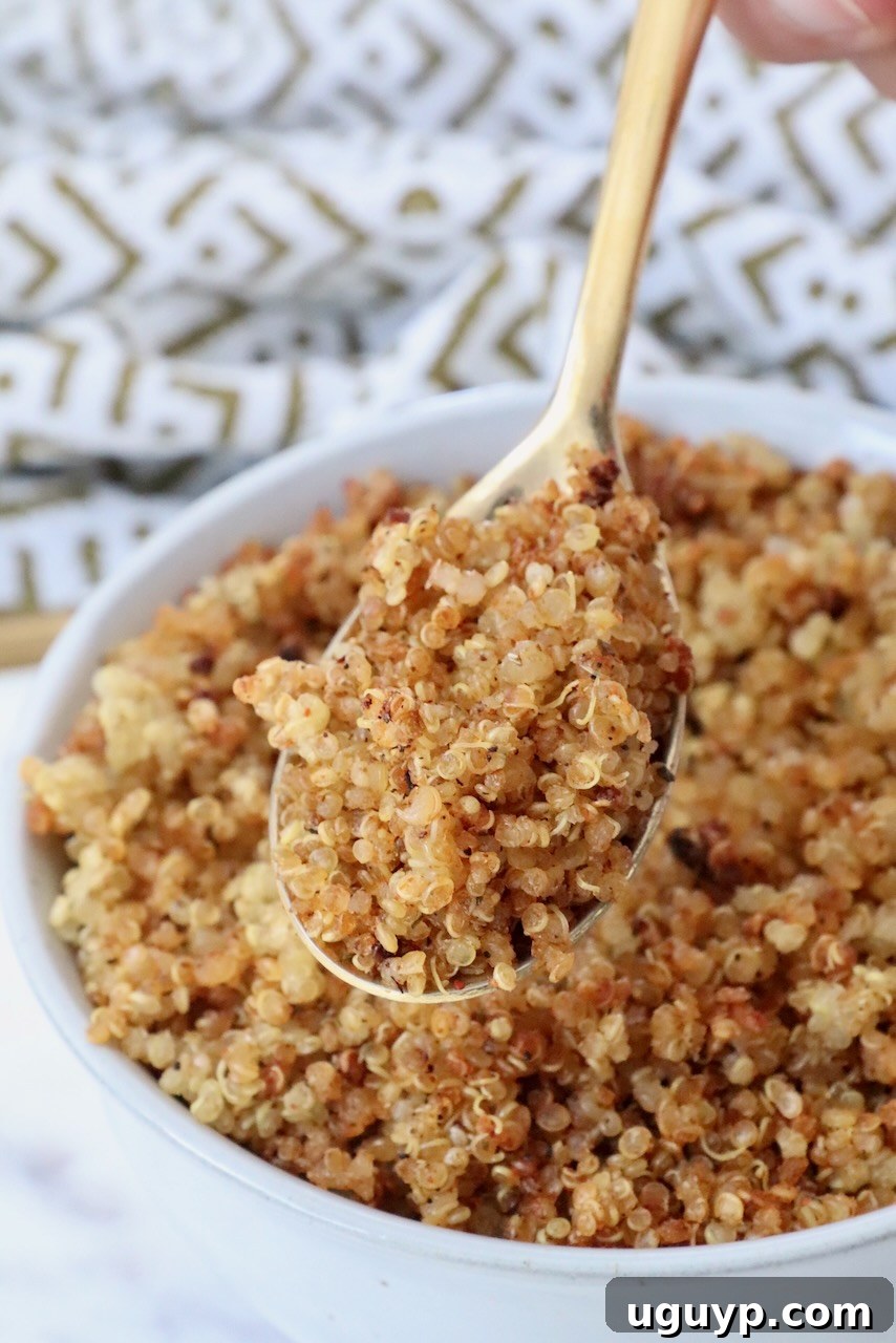 crispy quinoa in a spoon lifted out of a bowl