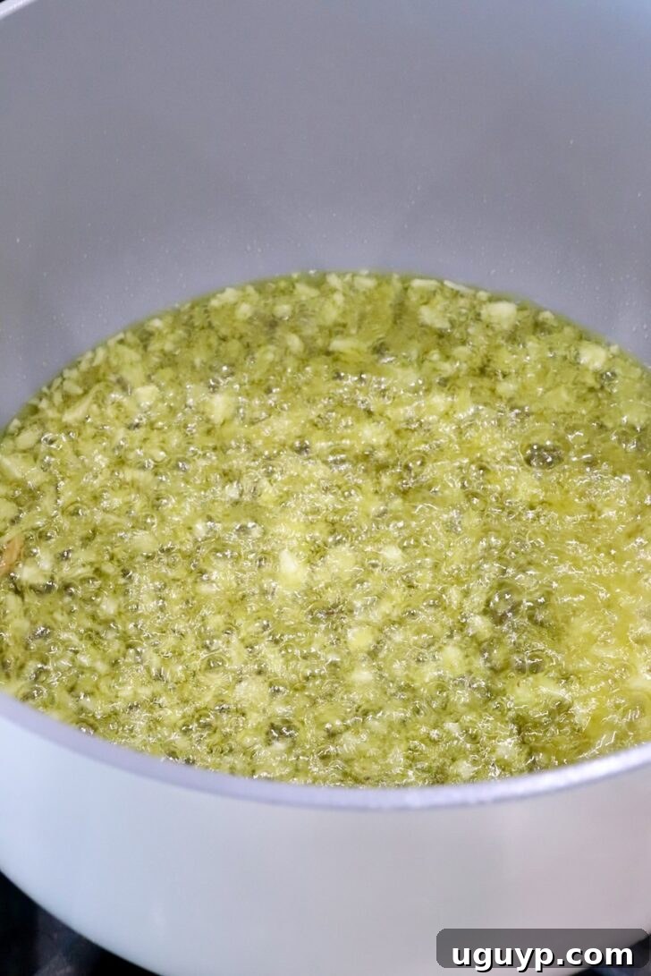 minced garlic in oil in a white pot