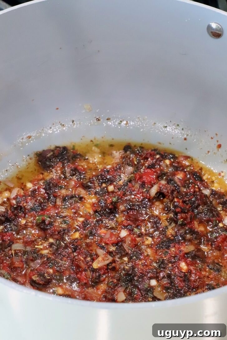 sun dried  tomatoes mixed with melted butter and seasonings in a saucepan