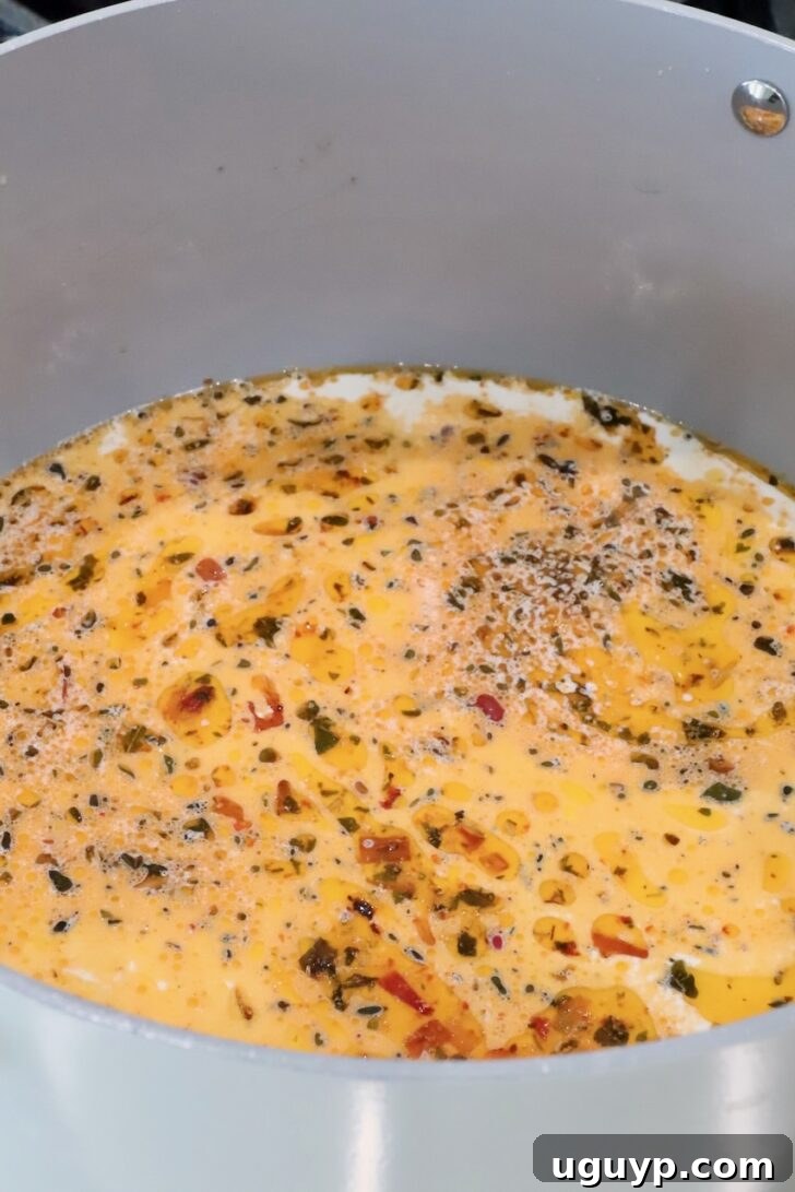 creamy tuscan pasta sauce in a pan on the stove