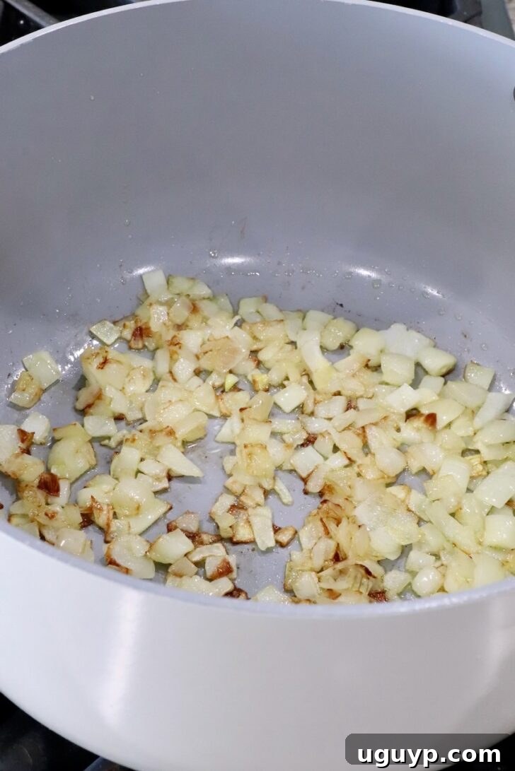cooked, diced onions in a large pot on the stove
