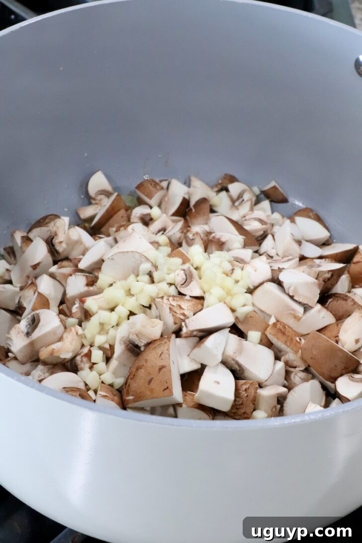 diced mushrooms and minced garlic in a pot on the stove