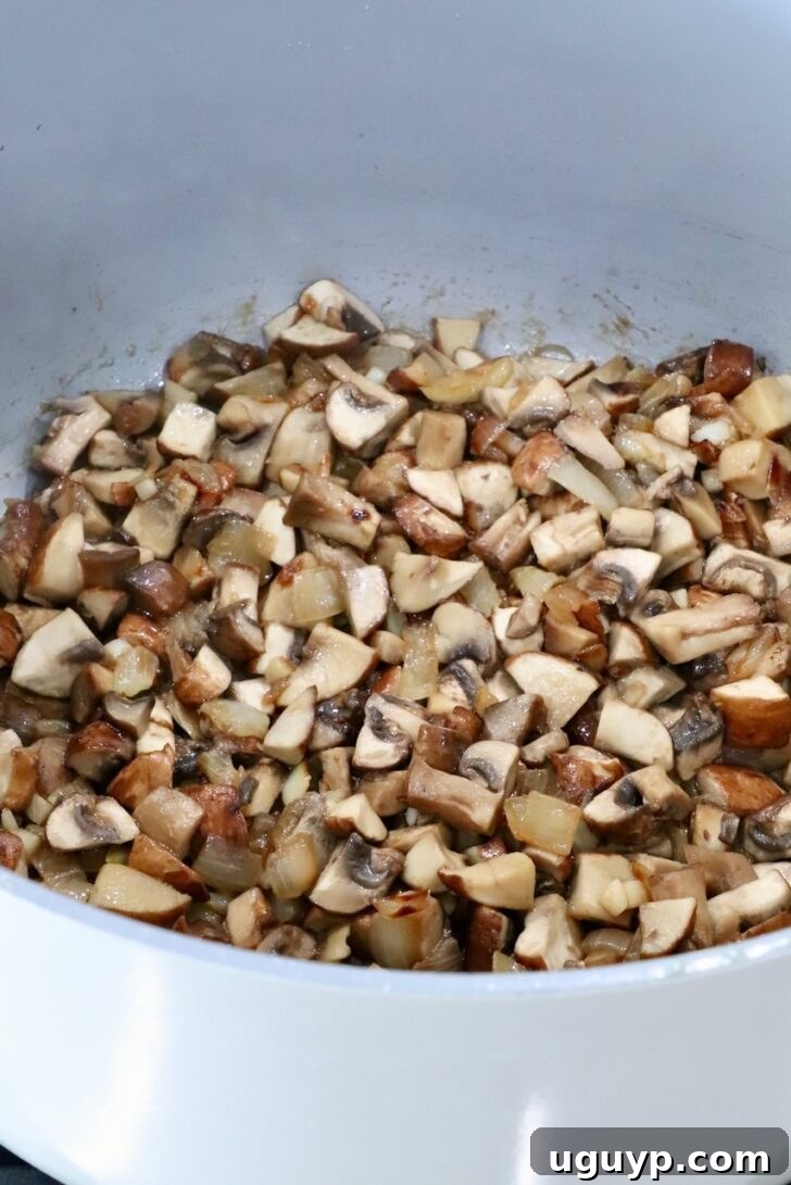 cooked diced mushrooms in a pot on the stove