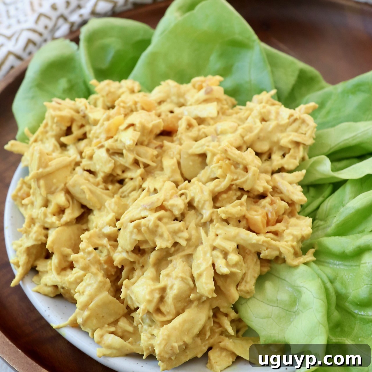 coronation chicken on plate with leaves of lettuce