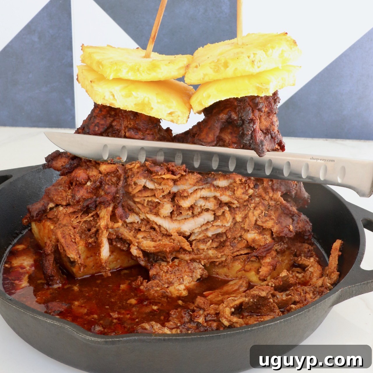 A stack of marinated, cooked pork layered on skewers, topped with pineapple slices