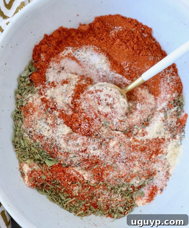 How to Use Blackened Seasoning: Tips for Bold, Smoky Flavor 6 dried herbs and spices mixed together in a bowl with a spoon