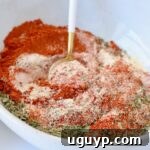 How to Use Blackened Seasoning: Tips for Bold, Smoky Flavor 8 dried herbs and spices combined in a bowl with a spoon