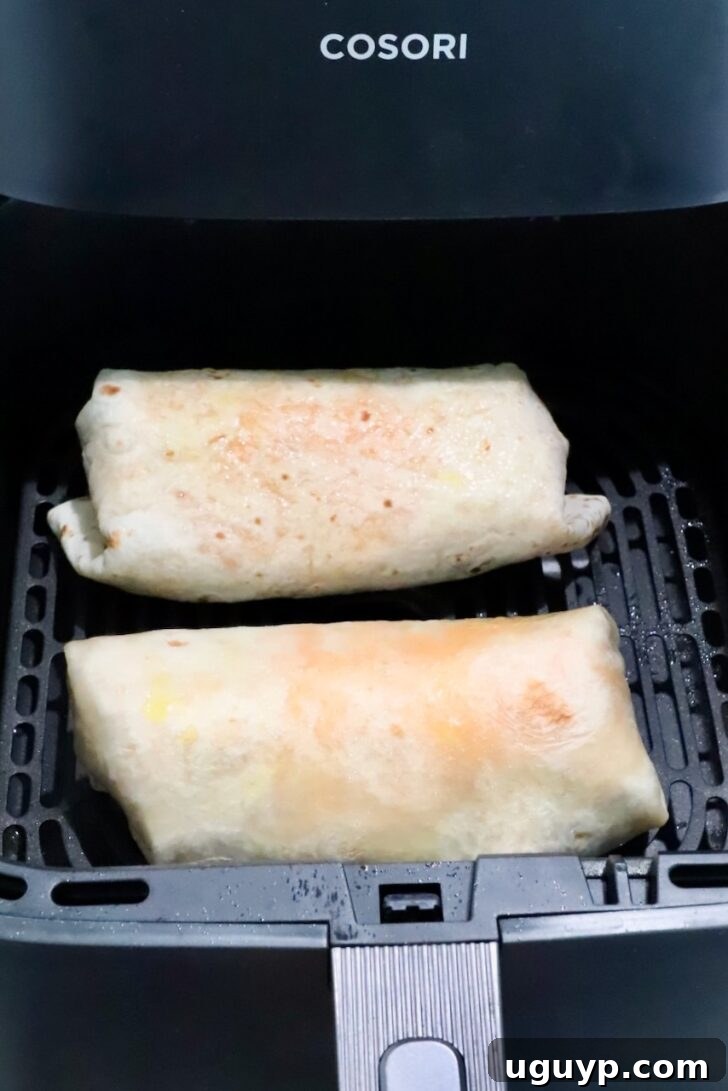 Cheesy Bean & Rice Burrito Recipe – Quick Weeknight Meal 14 two burritos in an air fryer basket