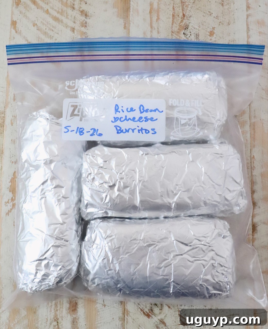 Cheesy Bean & Rice Burrito Recipe – Quick Weeknight Meal 16 burritos wrapped in foil in a plastic zipper bag