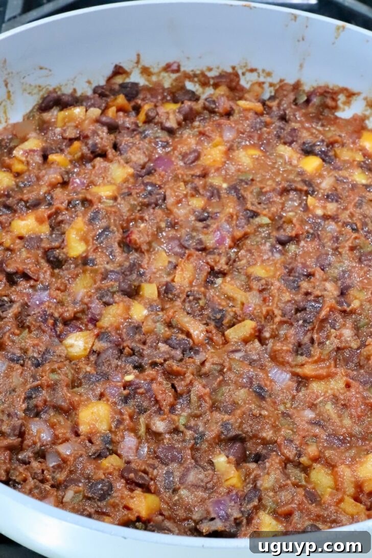 Cheesy Bean & Rice Burrito Recipe – Quick Weeknight Meal 8 bean burrito filling in a skillet