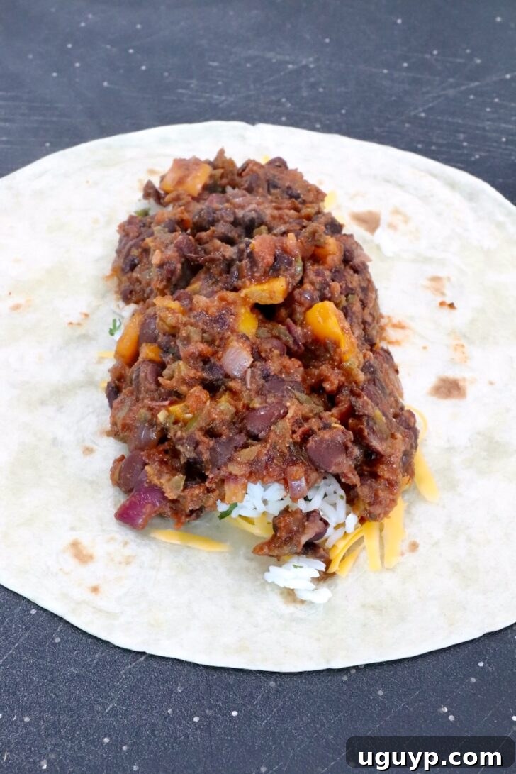 Cheesy Bean & Rice Burrito Recipe – Quick Weeknight Meal 10 bean filling in the middle of a tortilla
