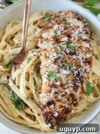 Creamy Chicken Caesar Pasta Recipe for Quick Weeknight Meals 13 crispy chicken on top of creamy fettuccine pasta in a bowl with a fork