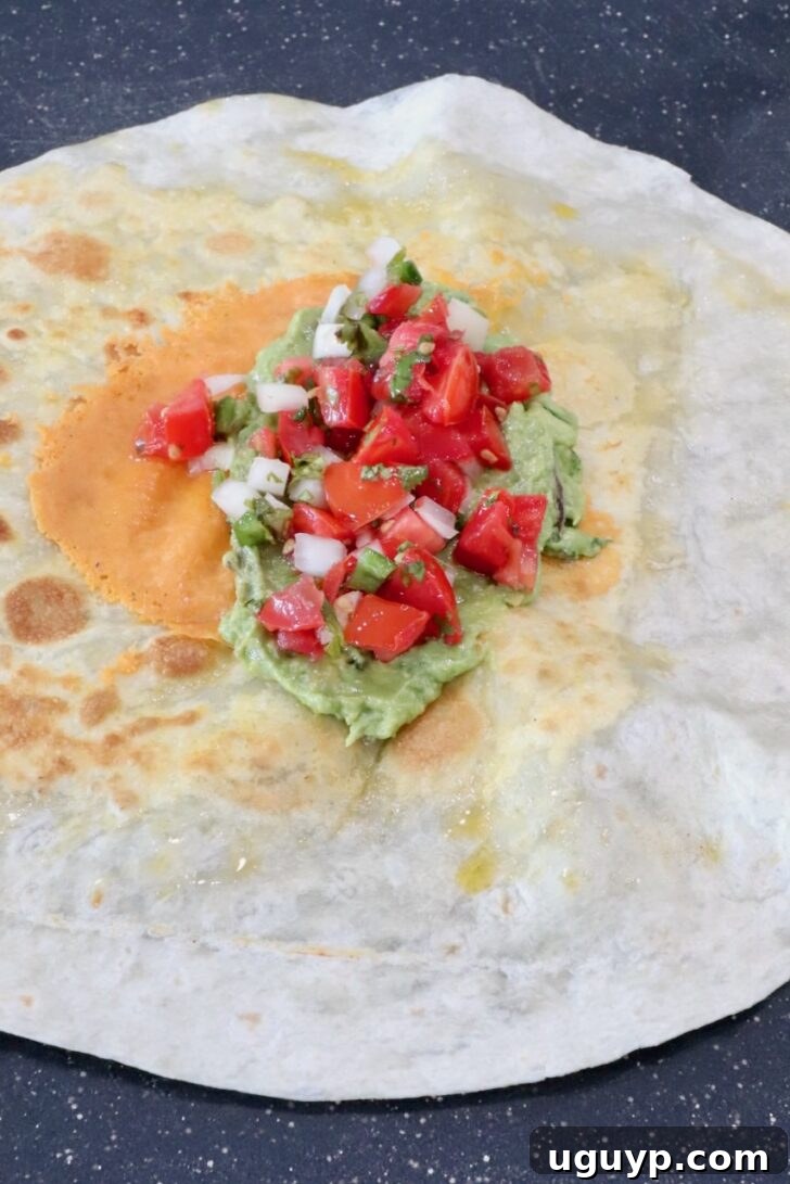 Classic California Burrito Recipe with Carne Asada & Fries 7 guacamole and pico de gallo in the middle of a tortilla