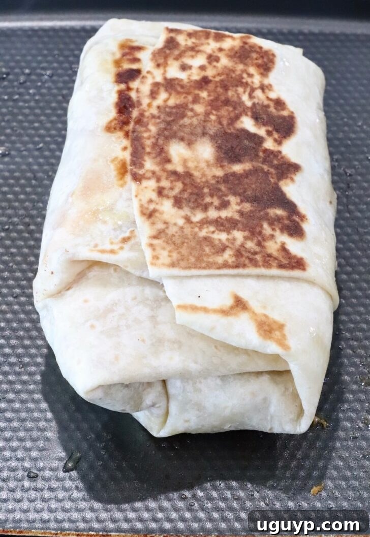 Classic California Burrito Recipe with Carne Asada & Fries 10 crispy toasted burrito on a griddle pan