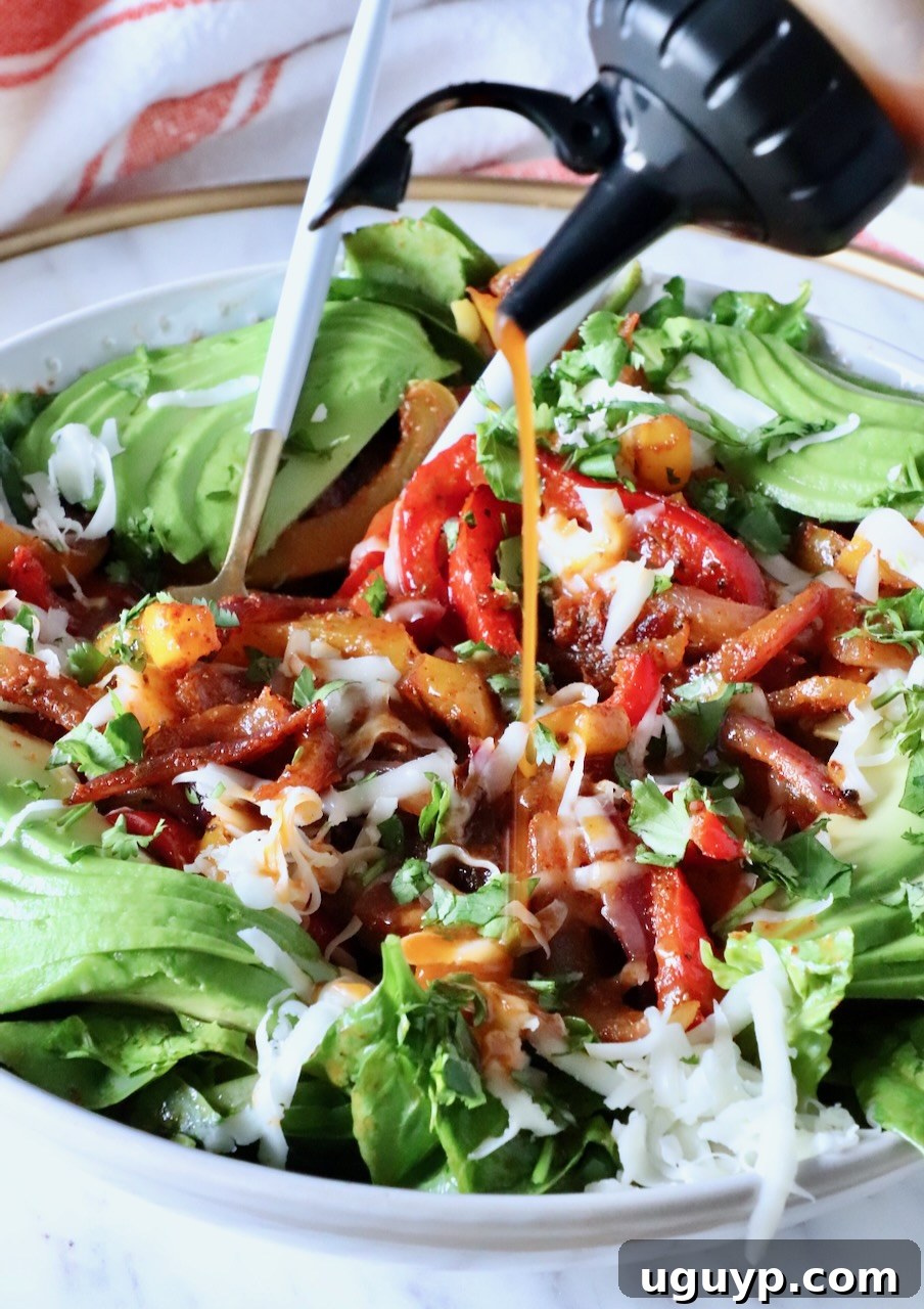 Zesty Chipotle Chicken Salad with Avocado 6 chipotle vinaigrette dressing poured over a salad in a bowl