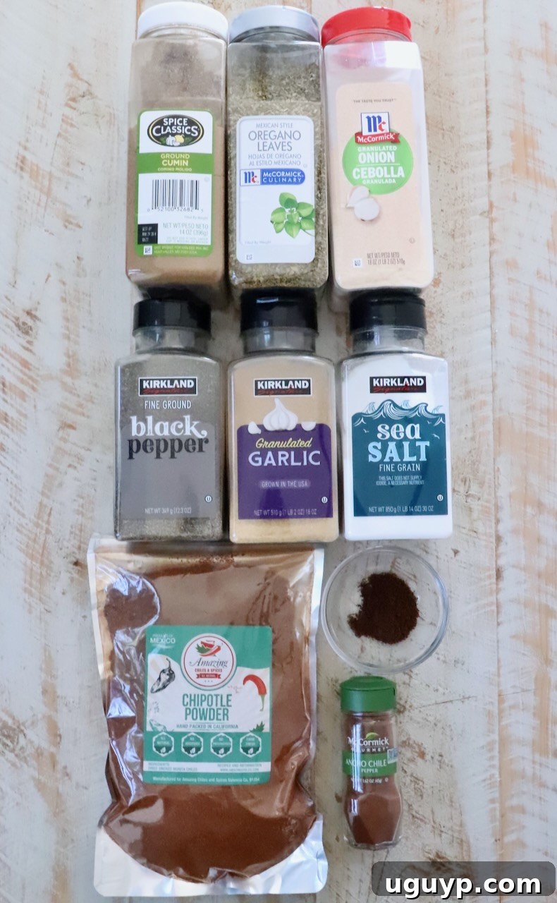 Authentic Mexican Barbacoa Seasoning Recipe 5 spices in plastic containers lined up on a white wood board