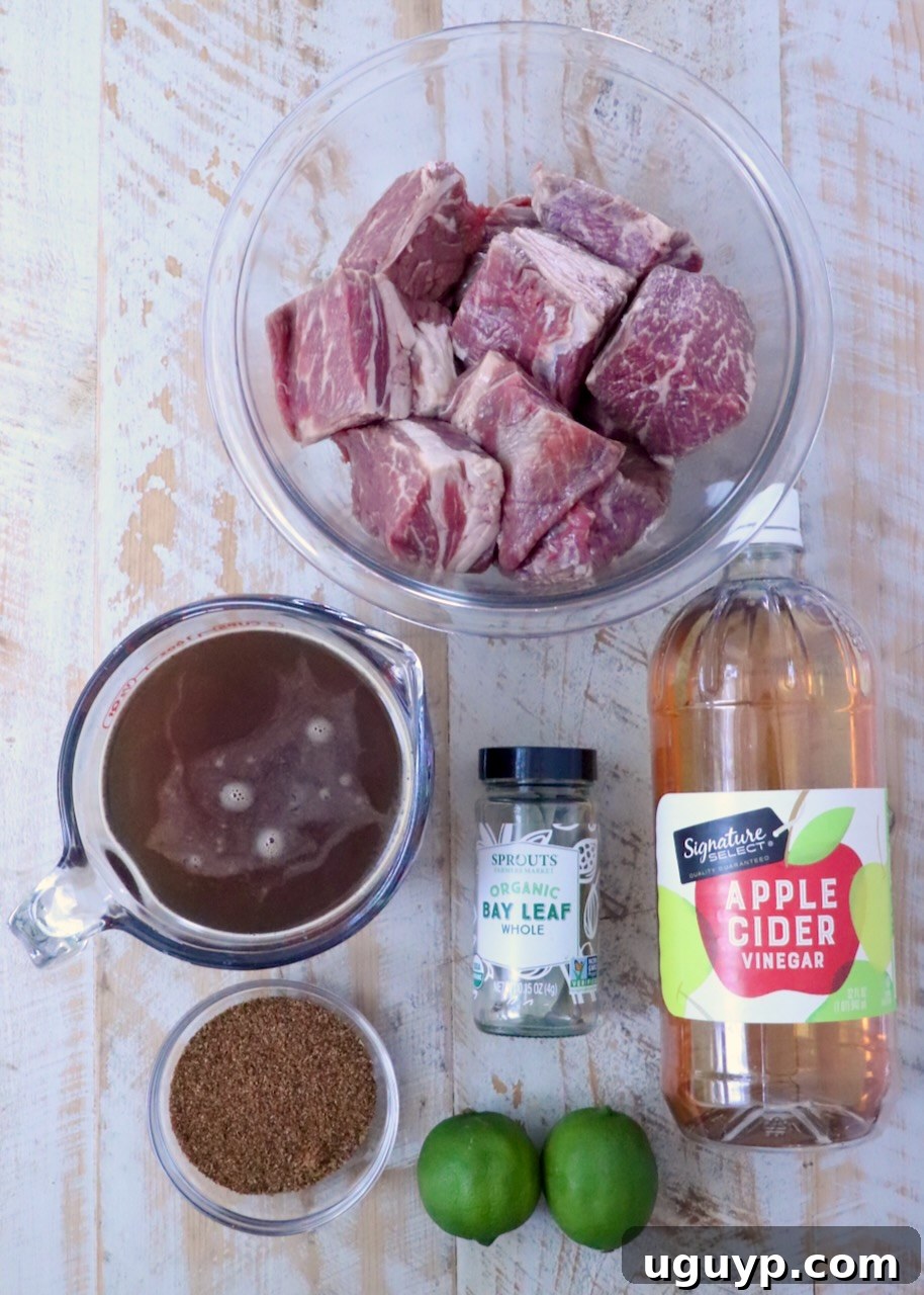 Instant Pot Beef Barbacoa - Tender Shredded Mexican Beef 5 ingredients for beef barbacoa on a white wood board