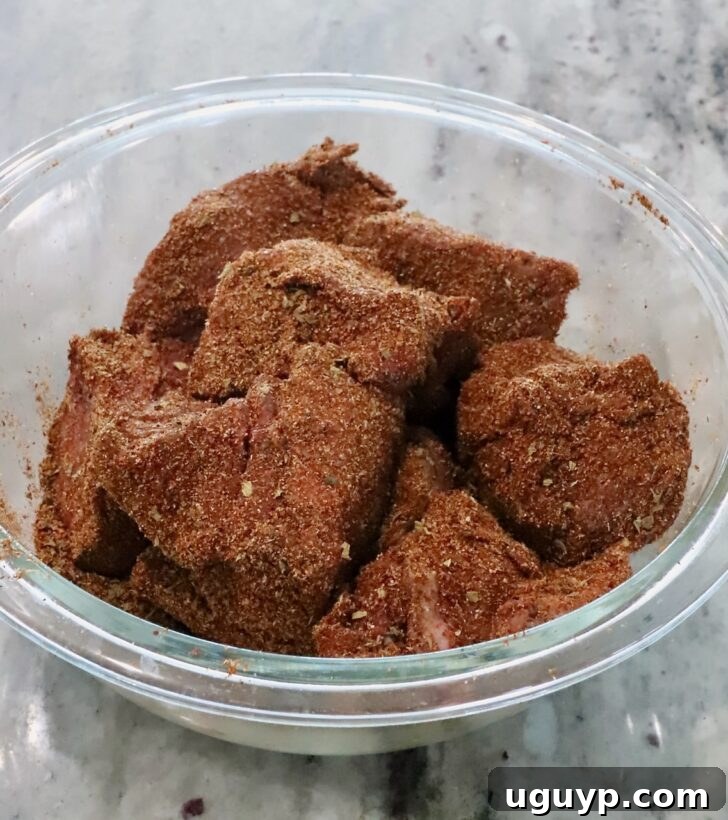 Instant Pot Beef Barbacoa - Tender Shredded Mexican Beef 6 seasoned chunks of beef in a glass bowl
