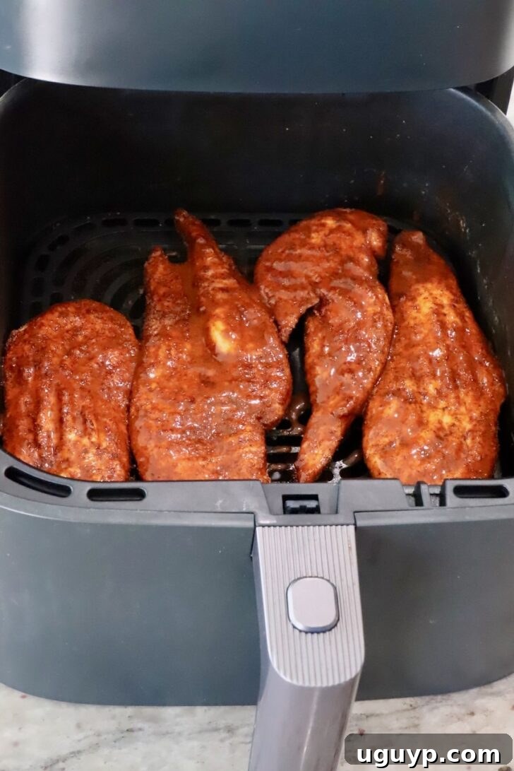 Crispy Buffalo Chicken Salad with Blue Cheese and Ranch 7 cooked chicken breasts brushed with buffalo sauce in an air fryer basket