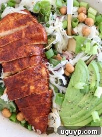 Crispy Buffalo Chicken Salad with Blue Cheese and Ranch 9 sliced buffalo chicken on top of a salad with sliced avocado
