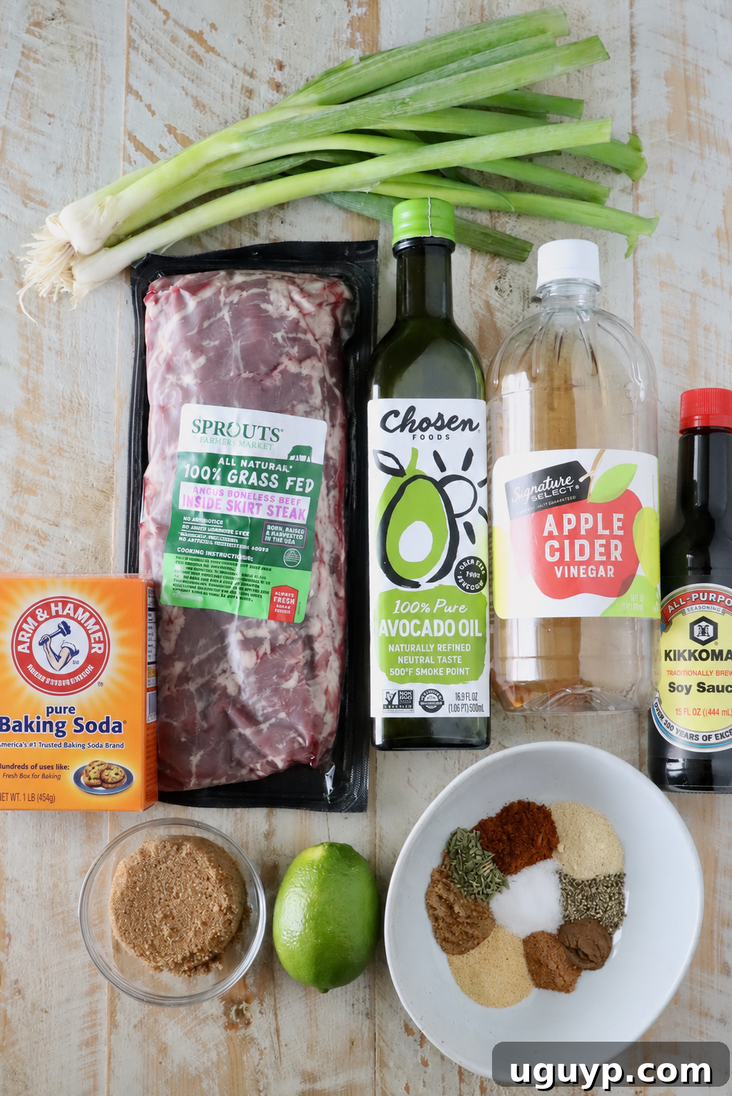 ingredients for jerk steak on a white wood board