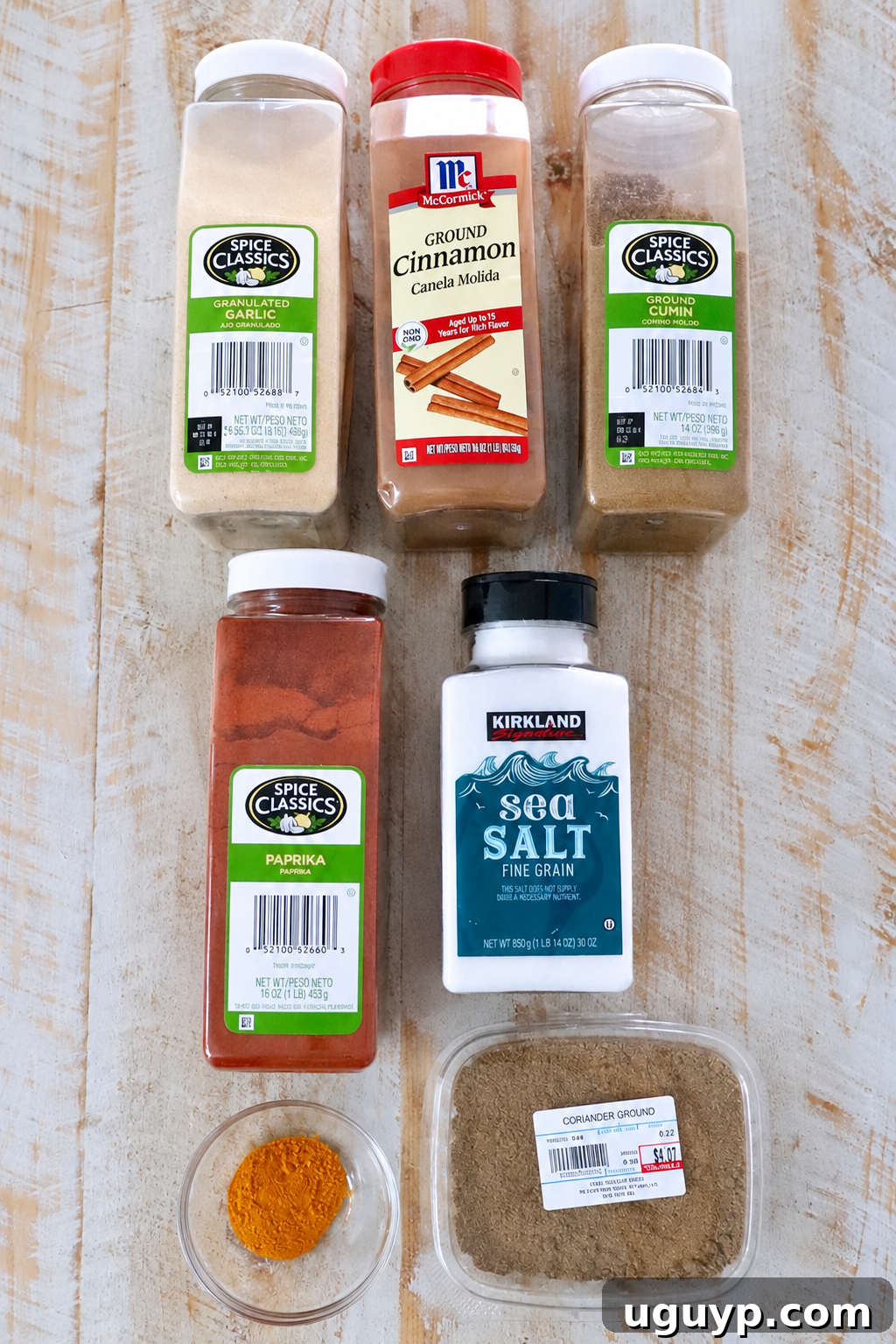 Homemade Chicken Shawarma Spice Blend 5 various spices in plastic containers on a white wood table