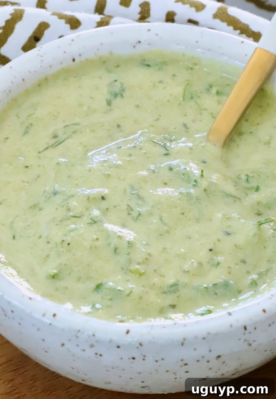 poblano ranch dressing in a bowl with a spoon