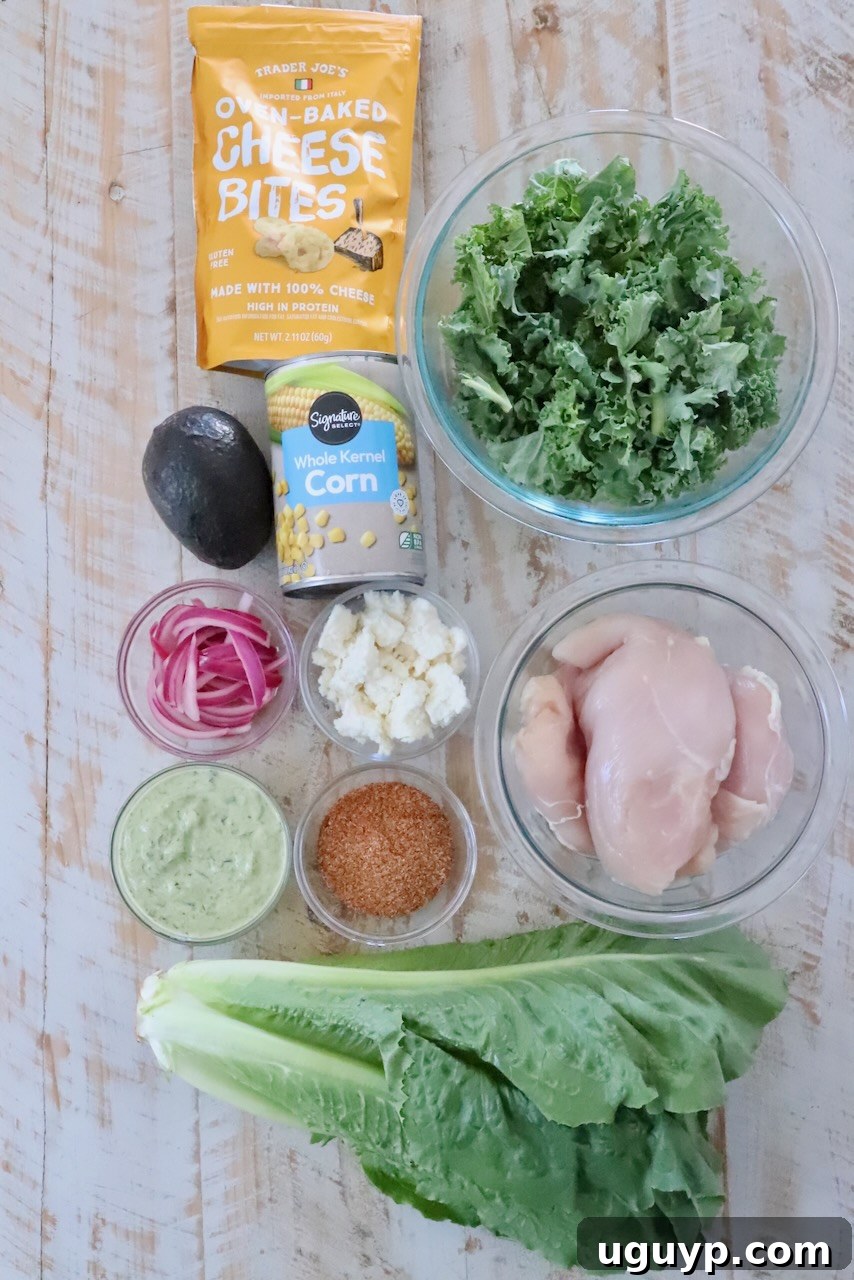ingredients for chicken taco salad on a white wooden table